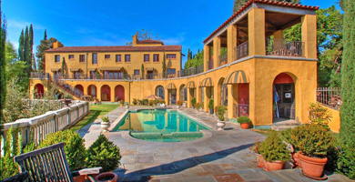 Guest house with seven glass doors and windows overlooking pool with views to downtown L.A. skyline, from The Villa Sophia